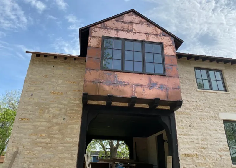 Copper metal panel facade on a stone building for Roof Repair in Fort Riley
